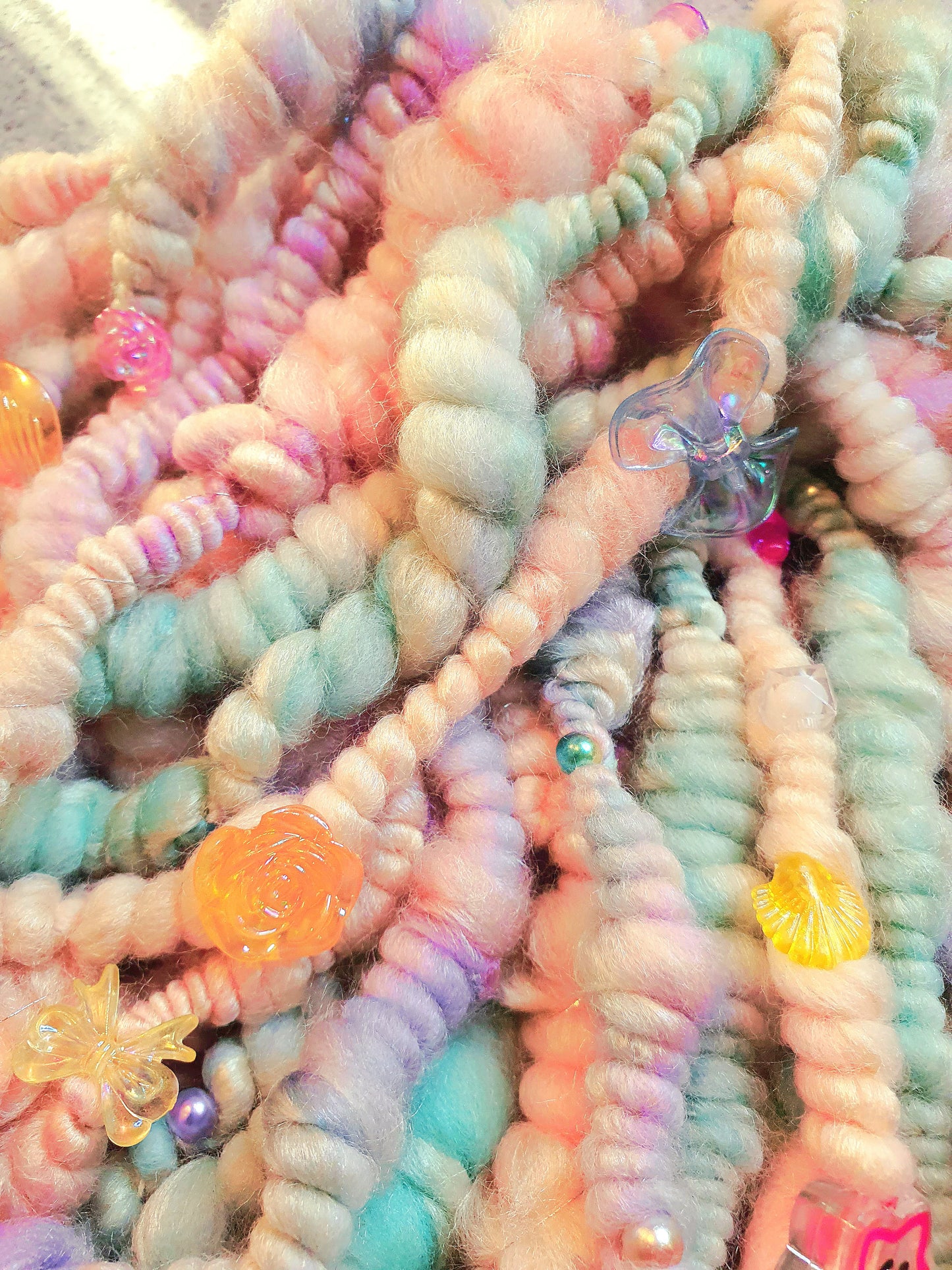 Beaded mermaid art yarn. Handspun art yarn in unicorn/mermaid colours.