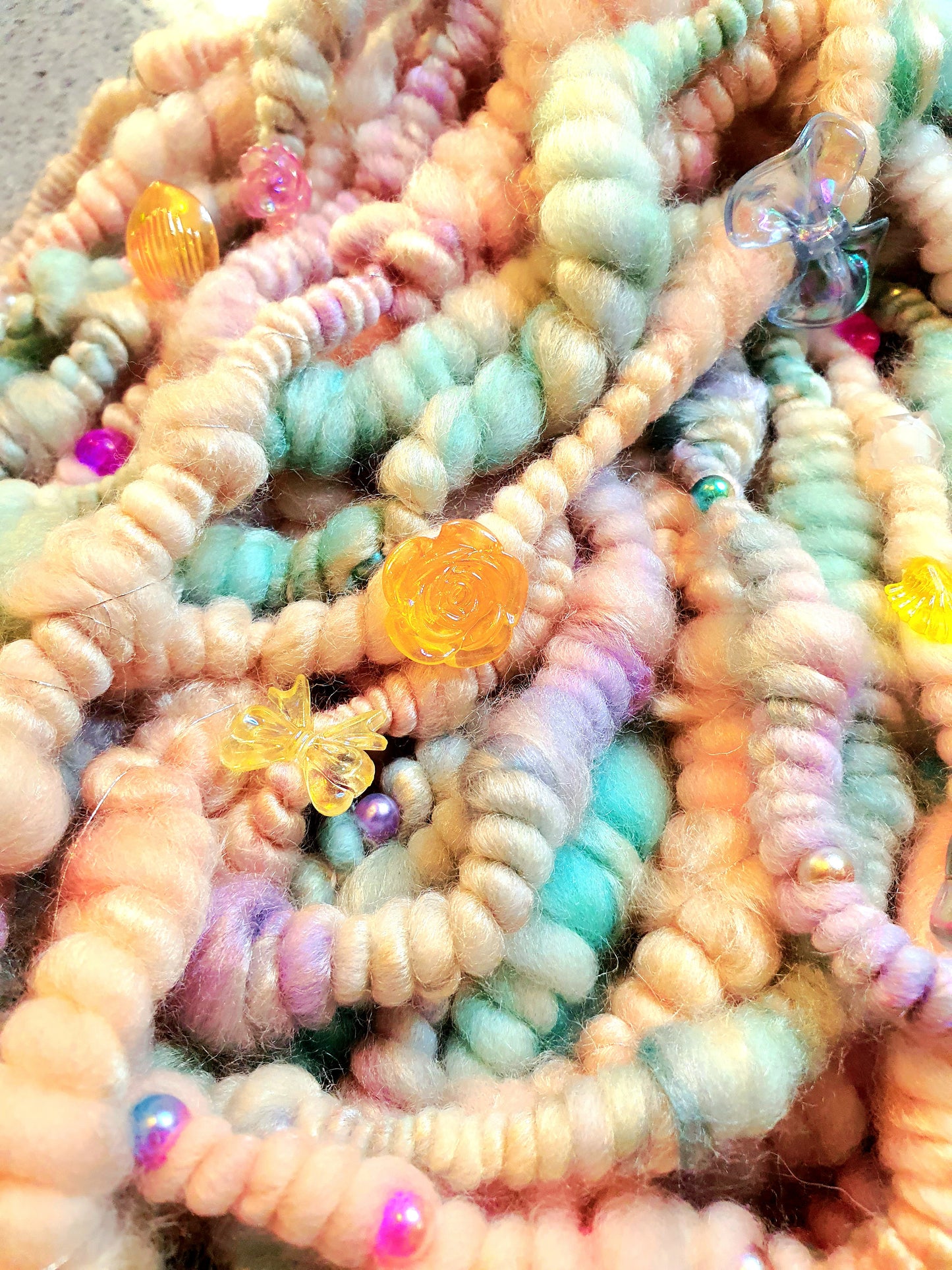 Beaded mermaid art yarn. Handspun art yarn in unicorn/mermaid colours.