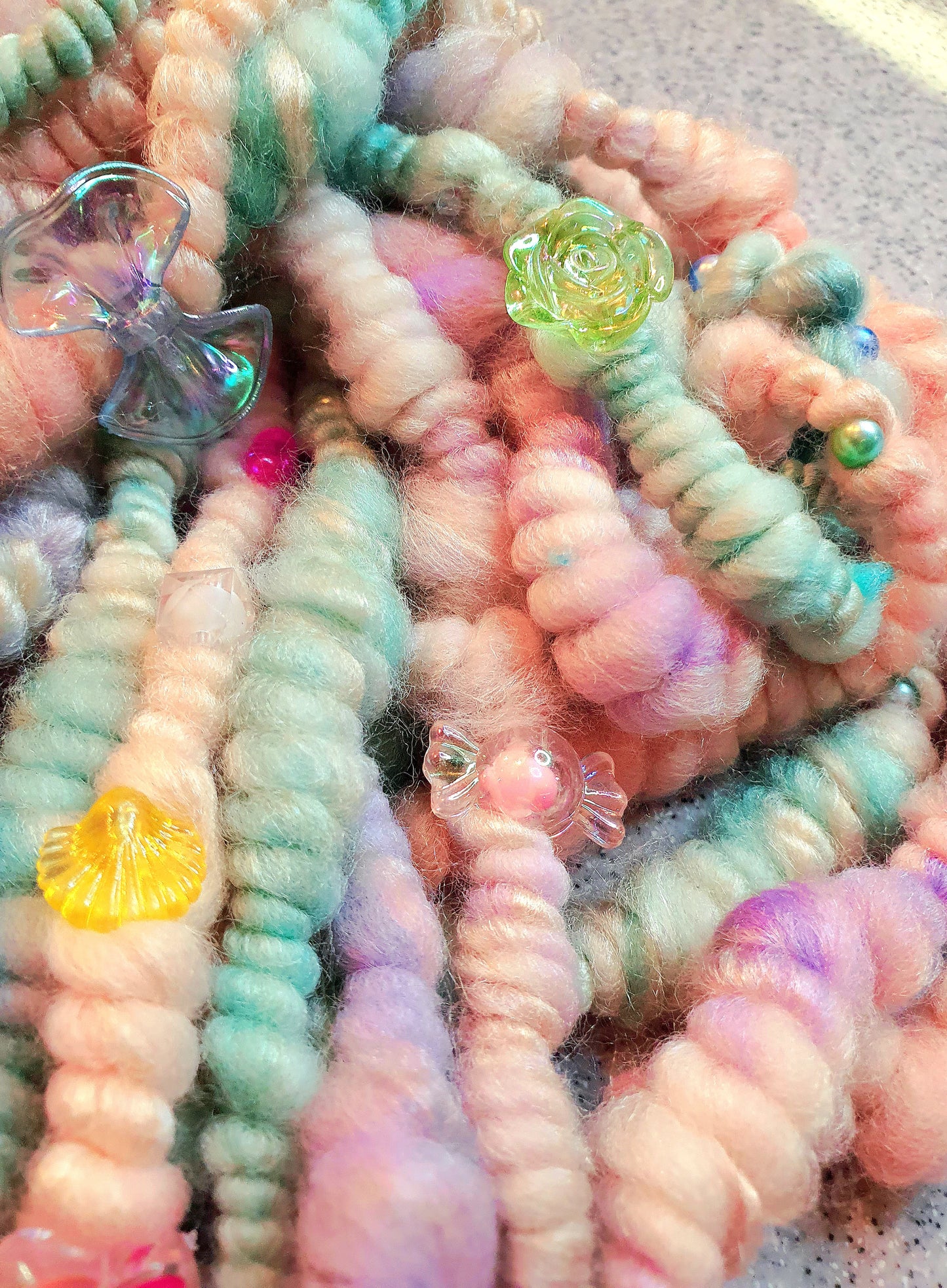 Beaded mermaid art yarn. Handspun art yarn in unicorn/mermaid colours.