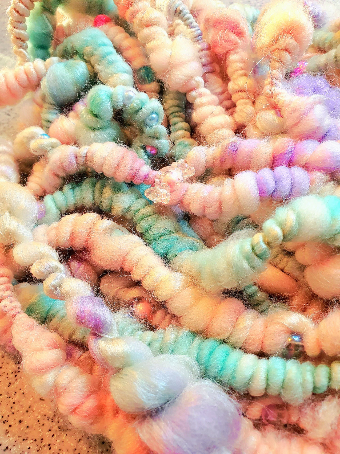 Beaded mermaid art yarn. Handspun art yarn in unicorn/mermaid colours.