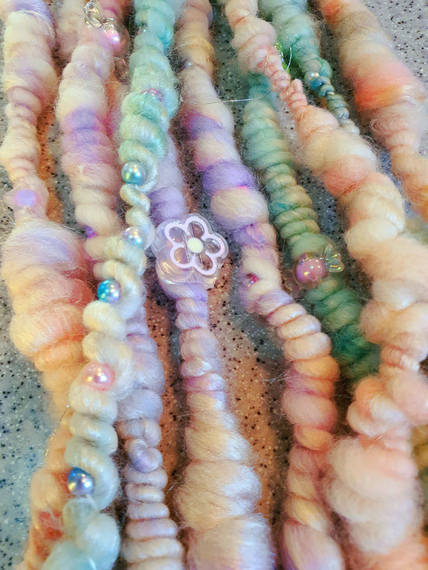 Beaded mermaid art yarn. Handspun art yarn in unicorn/mermaid colours.