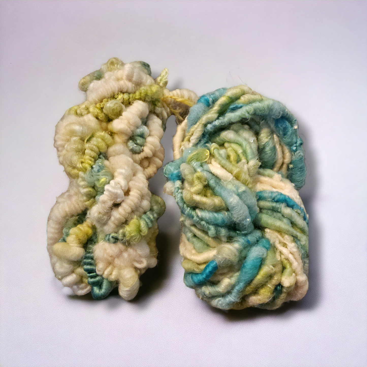 Hand-spun art yarn in Beautiful blues and greens. (Super chunky yarn)