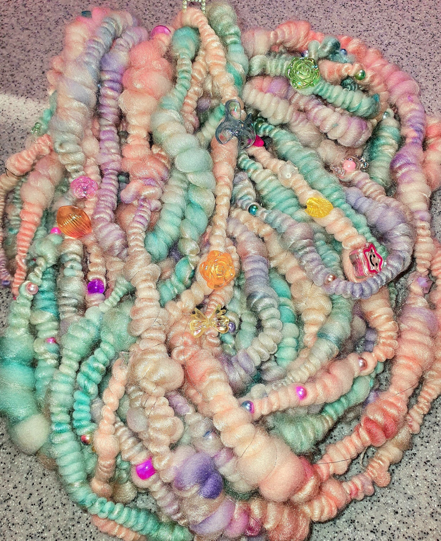 Beaded mermaid art yarn. Handspun art yarn in unicorn/mermaid colours.